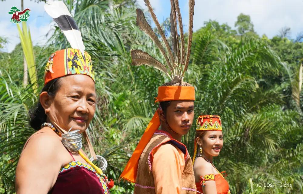 Dayak community members in traditional dress in the Borneo rainforest
