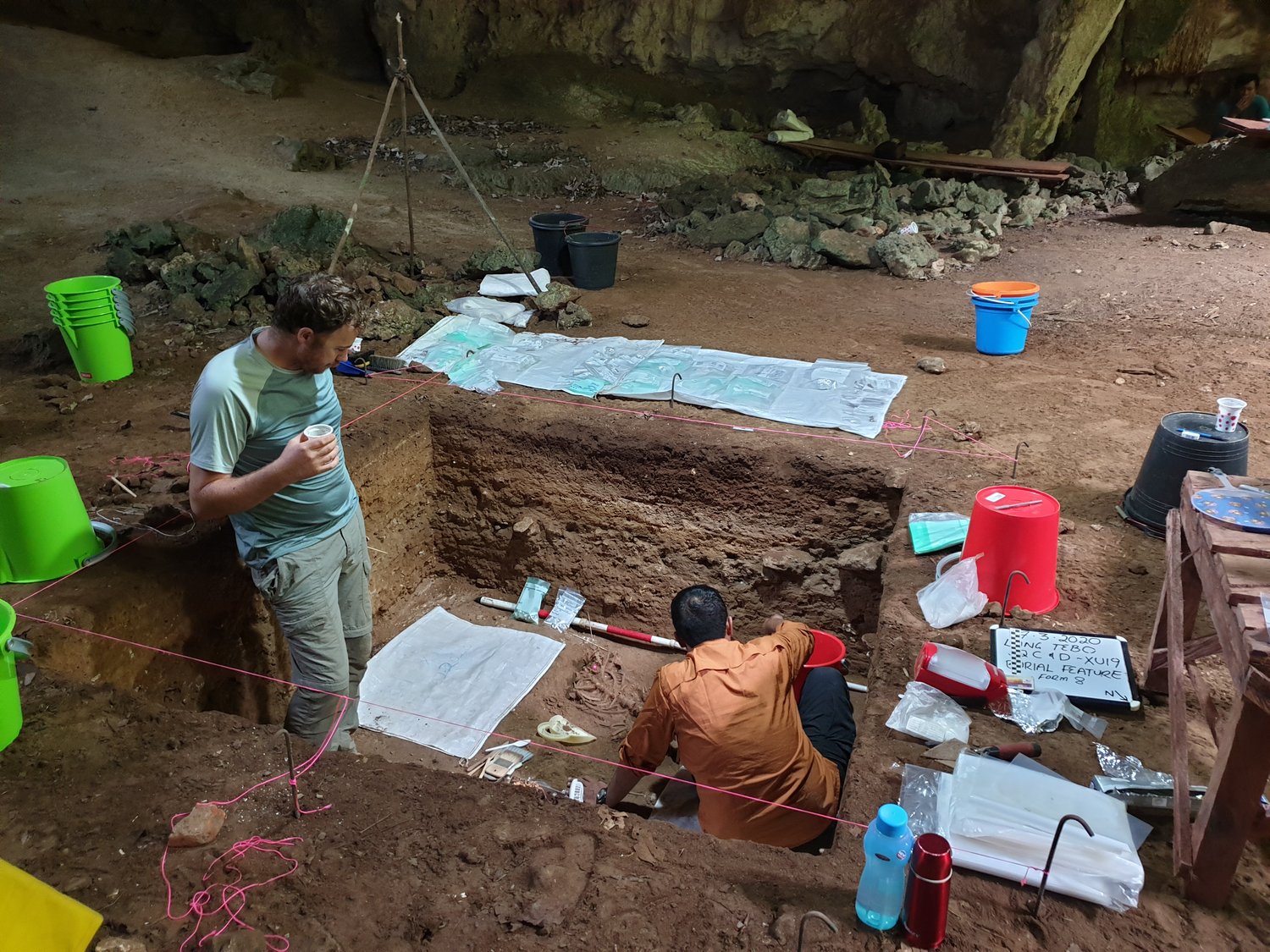 Researchers excavating the burial pit inside Liang Tebo cave